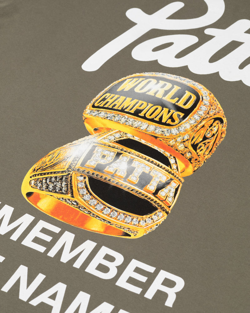 Close-up of the championship ring graphic on the dusty olive Patta Championship T-shirt.